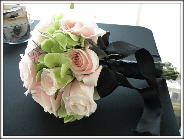 A handtied bouquet of light green hydrangea pale pink roses and black 