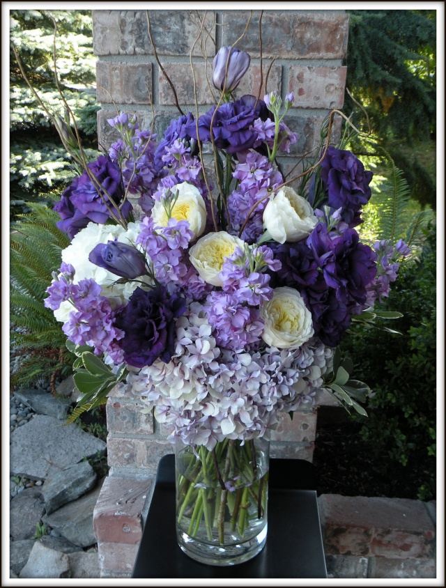 The altar arrangements had a variety of purple flowers including hydrangea 
