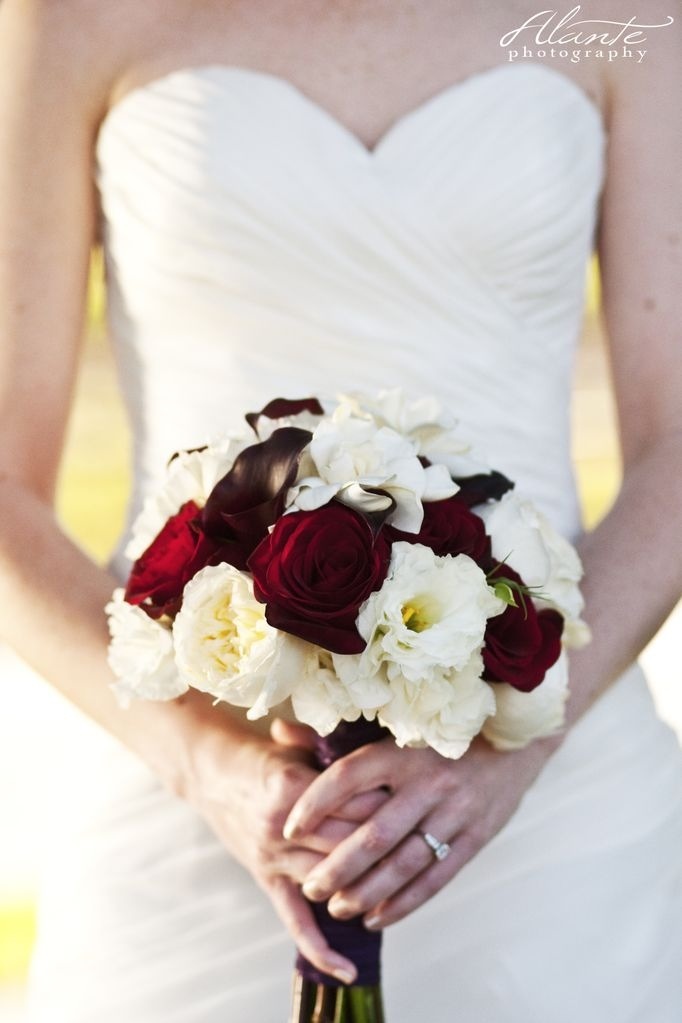 The Bridal Bouquet A handtied bouquet of deep red roses dark purple mini 
